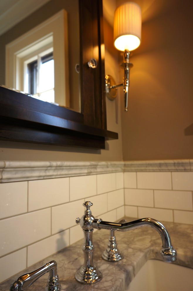 Example of a mid-sized classic master white tile and subway tile marble floor doorless shower design in Minneapolis with flat-panel cabinets, black cabinets, a one-piece toilet, gray walls, an undermount sink and marble countertops