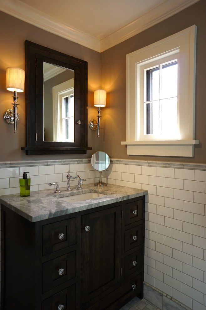 Inspiration for a mid-sized timeless master white tile and subway tile marble floor alcove shower remodel in Minneapolis with an undermount sink, shaker cabinets, black cabinets, marble countertops, a one-piece toilet and gray walls