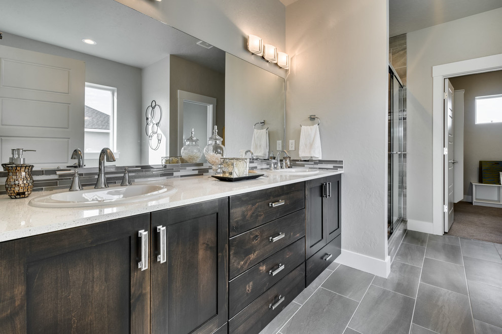 Inspiration for a medium sized traditional ensuite bathroom in Boise with shaker cabinets, dark wood cabinets, a built-in bath, an alcove shower, a two-piece toilet, grey tiles, ceramic tiles, beige walls, ceramic flooring, a built-in sink and quartz worktops.