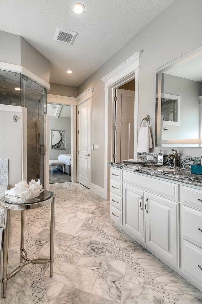Inspiration for a large timeless master multicolored tile and stone tile ceramic tile bathroom remodel in Salt Lake City with raised-panel cabinets, white cabinets, a two-piece toilet, gray walls, an undermount sink and marble countertops