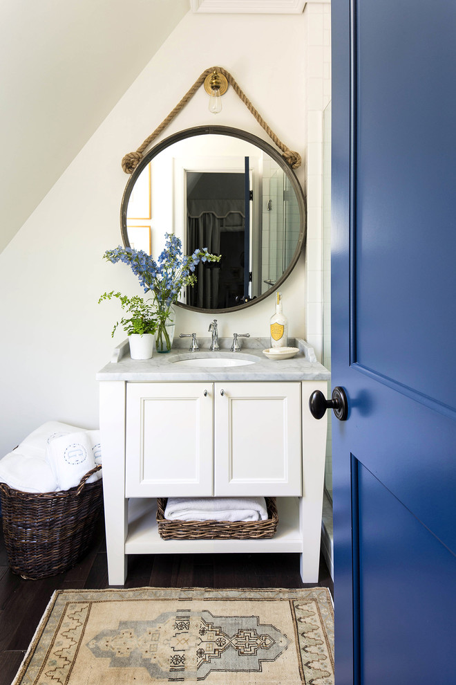 Inspiration for a small classic shower room bathroom in Birmingham with white cabinets, recessed-panel cabinets, white walls, dark hardwood flooring, a submerged sink, a shower/bath combination, marble worktops, an alcove bath, white tiles, ceramic tiles, brown floors, a hinged door and grey worktops.