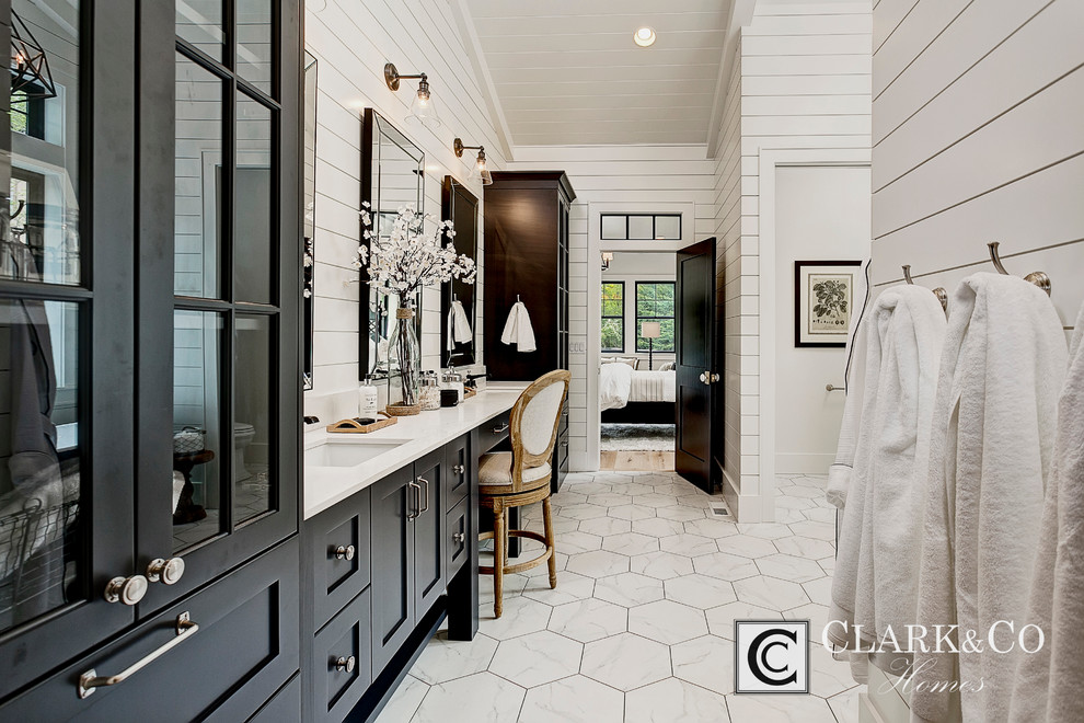 Expansive farmhouse ensuite bathroom in Boise with shaker cabinets, black cabinets, a freestanding bath, an alcove shower, white tiles, stone tiles, white walls, marble flooring, a submerged sink and engineered stone worktops.