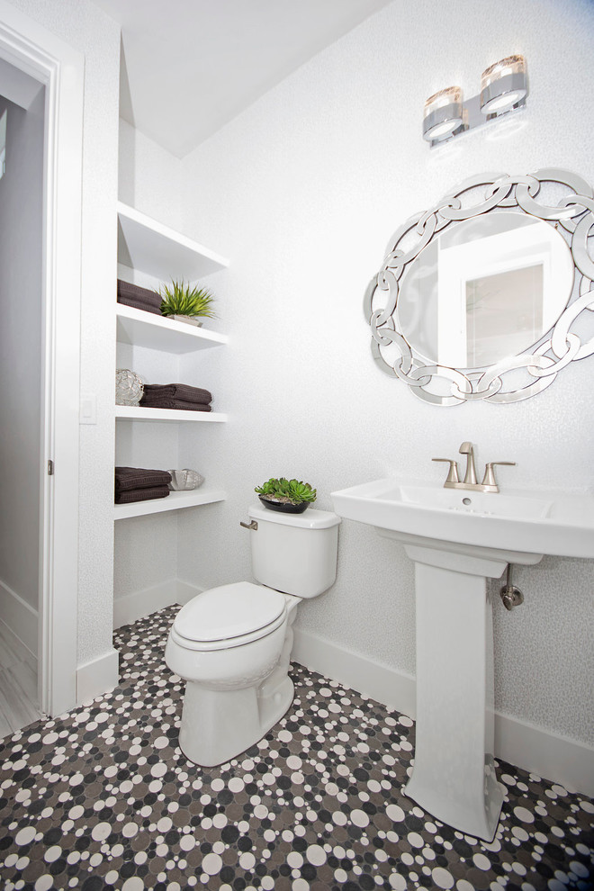 Large minimalist 3/4 ceramic tile bathroom photo in Miami with recessed-panel cabinets, a two-piece toilet, white walls and a pedestal sink