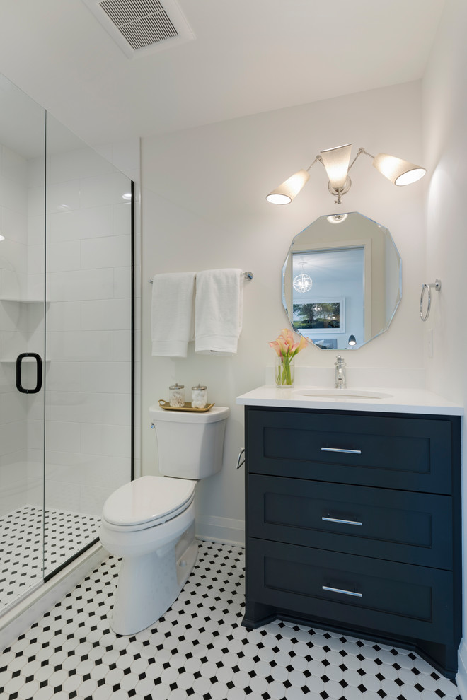 Alcove shower - small transitional 3/4 white tile ceramic tile and white floor alcove shower idea in Minneapolis with shaker cabinets, black cabinets, white walls, an undermount sink, quartz countertops, a hinged shower door and white countertops