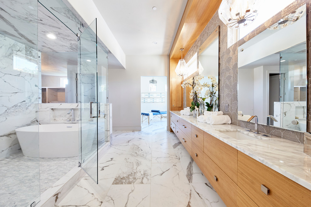Design ideas for an expansive contemporary ensuite wet room bathroom in Dallas with flat-panel cabinets, medium wood cabinets, a freestanding bath, a two-piece toilet, grey tiles, glass tiles, white walls, porcelain flooring, a submerged sink, quartz worktops, a hinged door and white floors.