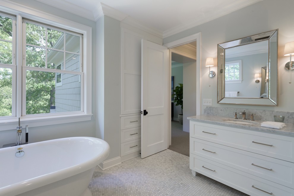 Design ideas for a medium sized nautical ensuite bathroom in Minneapolis with shaker cabinets, white cabinets, a freestanding bath, an alcove shower, a two-piece toilet, white tiles, ceramic tiles, grey walls, mosaic tile flooring, a submerged sink, marble worktops, white floors, a hinged door and white worktops.