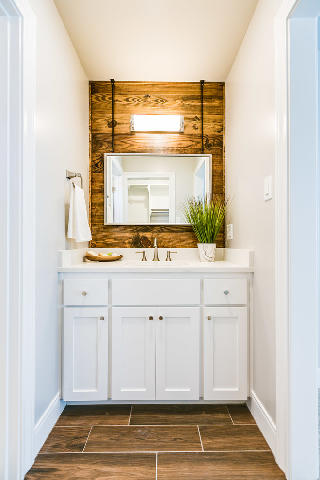 Photo of a medium sized classic family bathroom in Austin with shaker cabinets, white cabinets, an alcove bath, a shower/bath combination, a one-piece toilet, white tiles, porcelain tiles, white walls, porcelain flooring, a submerged sink, engineered stone worktops, brown floors and a shower curtain.