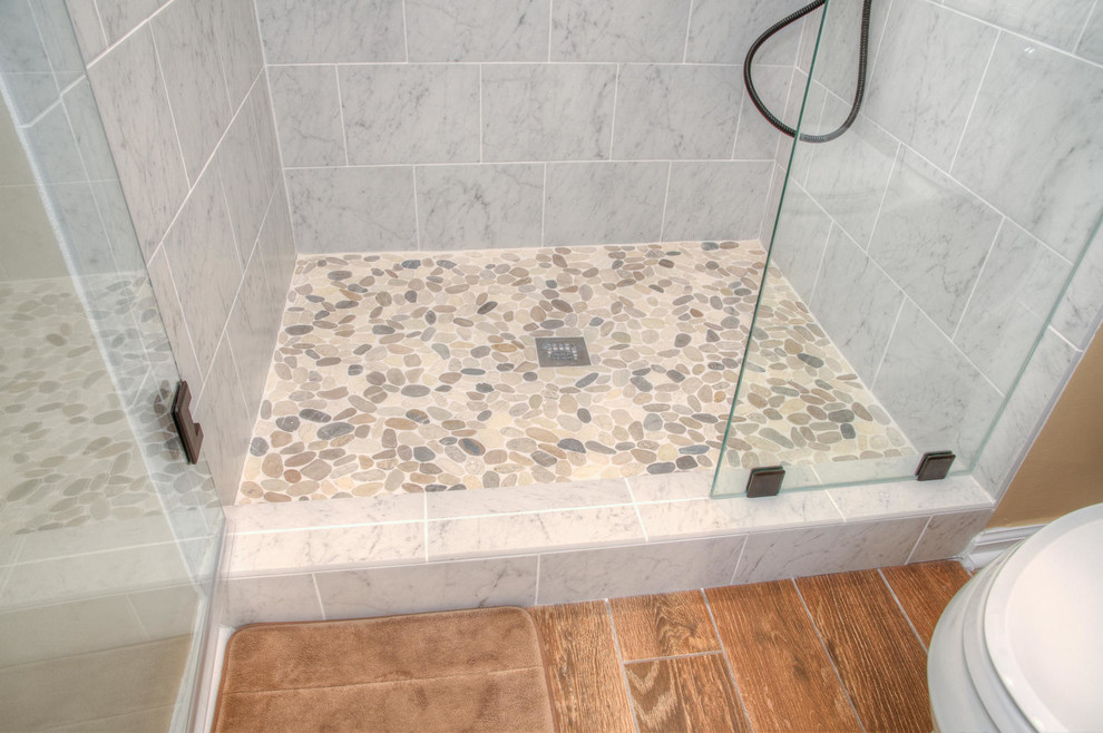 Example of a large transitional master beige tile and ceramic tile medium tone wood floor alcove shower design in Other with shaker cabinets, white cabinets, an undermount sink, granite countertops and yellow walls