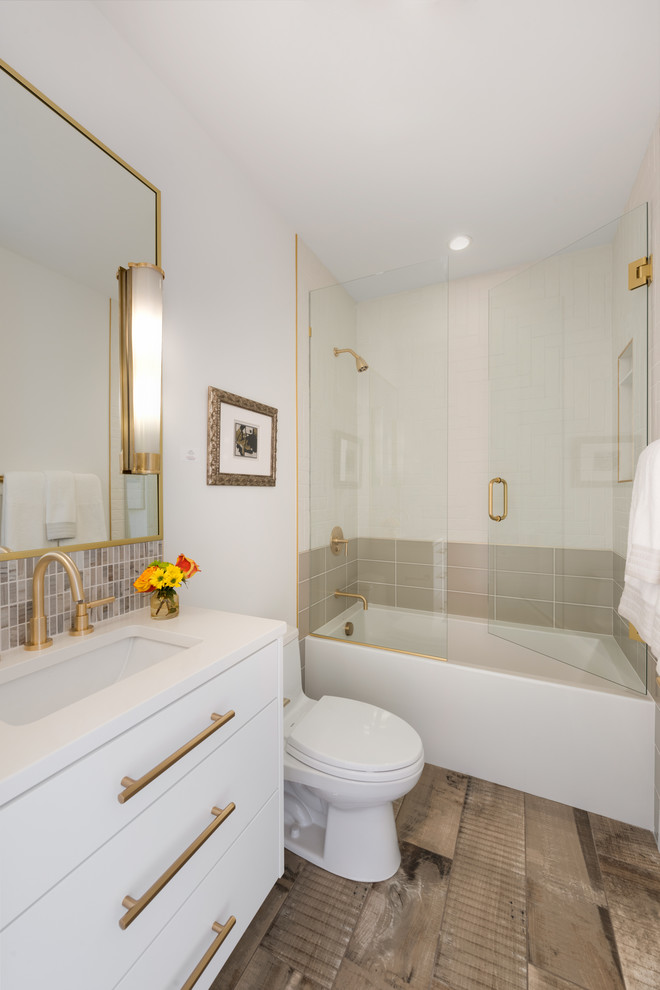 Inspiration for a mid-sized contemporary 3/4 white tile and porcelain tile brown floor and porcelain tile bathroom remodel in Minneapolis with flat-panel cabinets, white cabinets, white walls, an undermount sink, a hinged shower door, white countertops, a one-piece toilet and quartz countertops