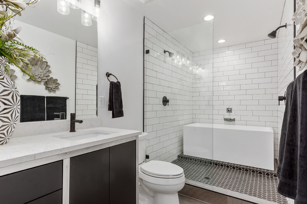 This is an example of a contemporary wet room bathroom in Salt Lake City with flat-panel cabinets, black cabinets, white tiles, white walls, mosaic tile flooring, a submerged sink, black floors, an open shower and white worktops.