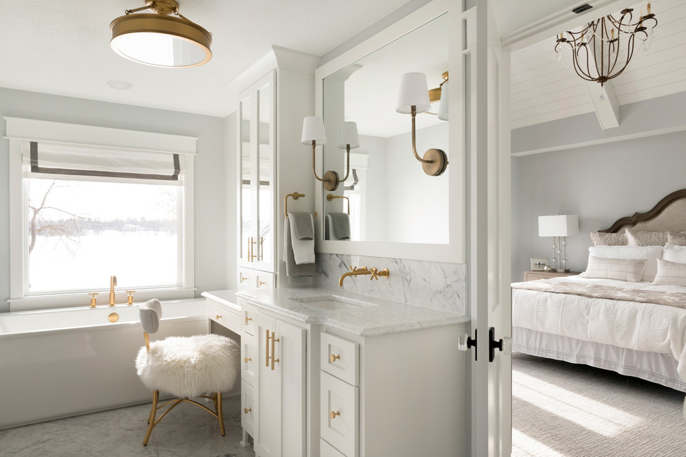 Large classic ensuite bathroom in Minneapolis with white cabinets, a freestanding bath, grey walls, marble flooring, a submerged sink, marble worktops, grey floors, white worktops and shaker cabinets.