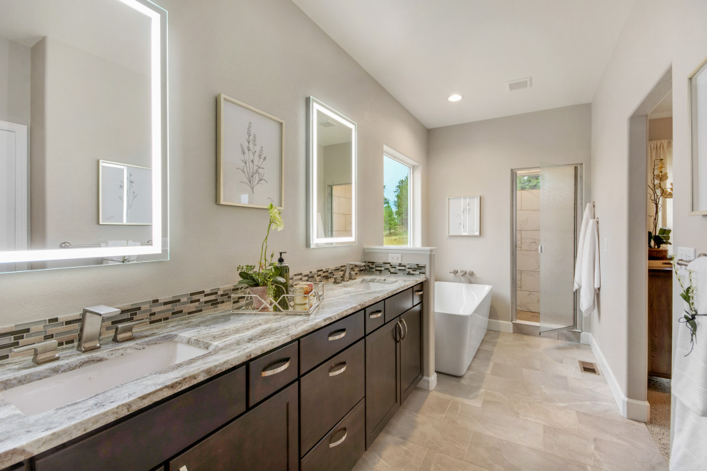 Inspiration for a mid-sized craftsman master gray tile and marble tile limestone floor and gray floor bathroom remodel in Denver with recessed-panel cabinets, brown cabinets, a two-piece toilet, gray walls, an undermount sink, limestone countertops, a hinged shower door and gray countertops