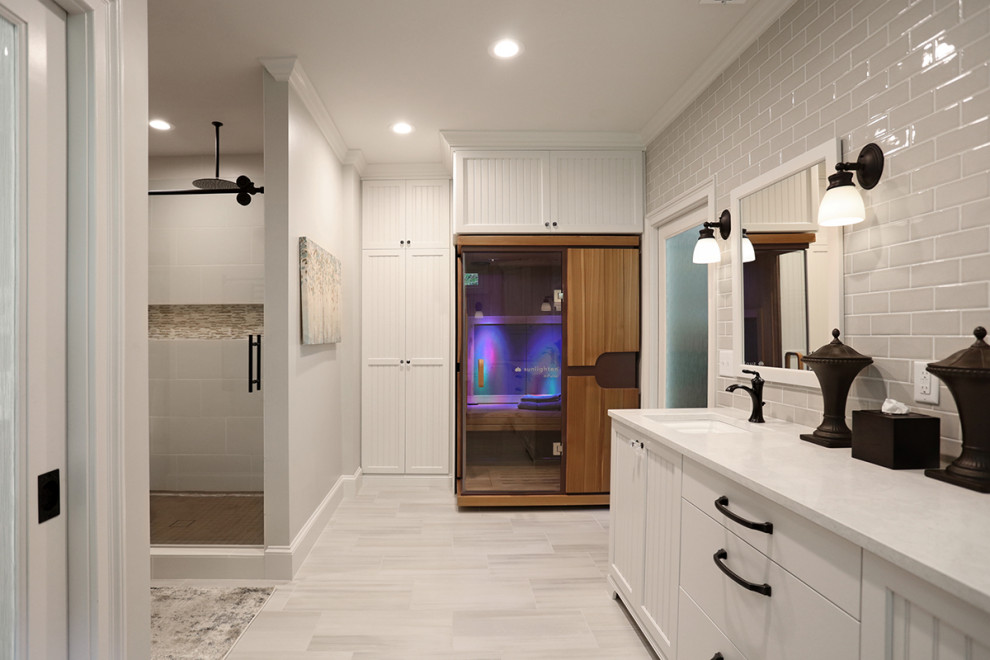 Design ideas for a large classic ensuite bathroom in Atlanta with freestanding cabinets, white cabinets, an alcove bath, an alcove shower, a one-piece toilet, metro tiles, porcelain flooring, a submerged sink, engineered stone worktops, a sliding door, white worktops, an enclosed toilet, double sinks and a freestanding vanity unit.
