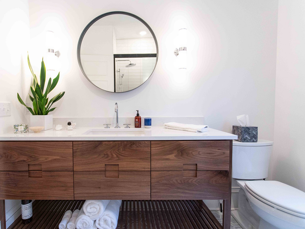 Mid-sized transitional 3/4 white tile porcelain tile, multicolored floor and single-sink bathroom photo in Minneapolis with flat-panel cabinets, medium tone wood cabinets, a one-piece toilet, gray walls, an undermount sink, quartz countertops, white countertops and a freestanding vanity