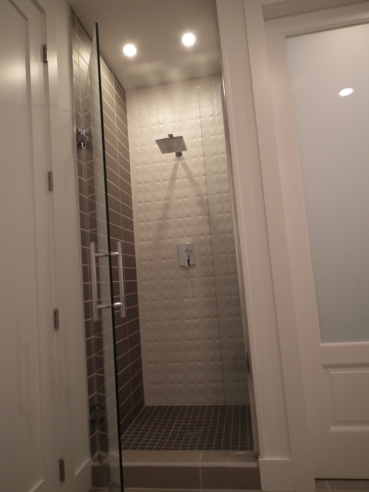 This is an example of a medium sized contemporary ensuite bathroom in Indianapolis with a vessel sink, flat-panel cabinets, white cabinets, engineered stone worktops, a one-piece toilet, white tiles, ceramic tiles, white walls and ceramic flooring.