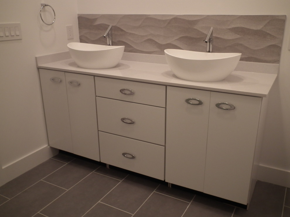Example of a mid-sized trendy master white tile and ceramic tile ceramic tile bathroom design in Indianapolis with a vessel sink, flat-panel cabinets, white cabinets, quartz countertops, a one-piece toilet and white walls