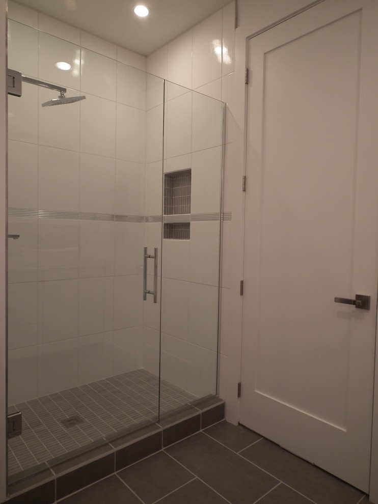 Photo of a medium sized contemporary ensuite bathroom in Indianapolis with a vessel sink, flat-panel cabinets, white cabinets, engineered stone worktops, a one-piece toilet, white tiles, ceramic tiles, white walls and ceramic flooring.