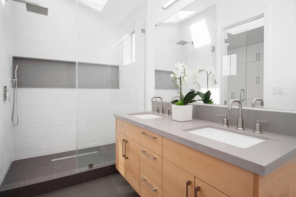 Mid-sized minimalist master white tile and ceramic tile slate floor and gray floor bathroom photo in Los Angeles with flat-panel cabinets, medium tone wood cabinets, a one-piece toilet, white walls, an undermount sink, quartz countertops and gray countertops