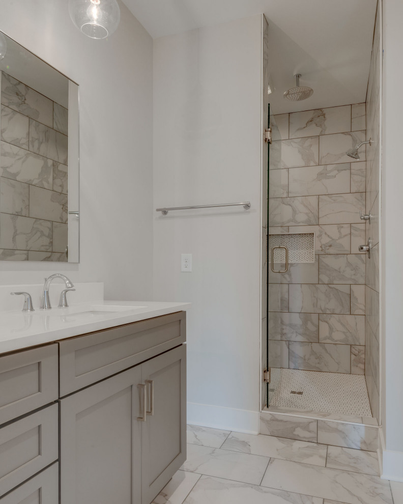 Elegant master white tile and porcelain tile porcelain tile, white floor and double-sink bathroom photo in Nashville with shaker cabinets, gray cabinets, white walls, an undermount sink, quartz countertops, a hinged shower door, white countertops, a niche and a built-in vanity