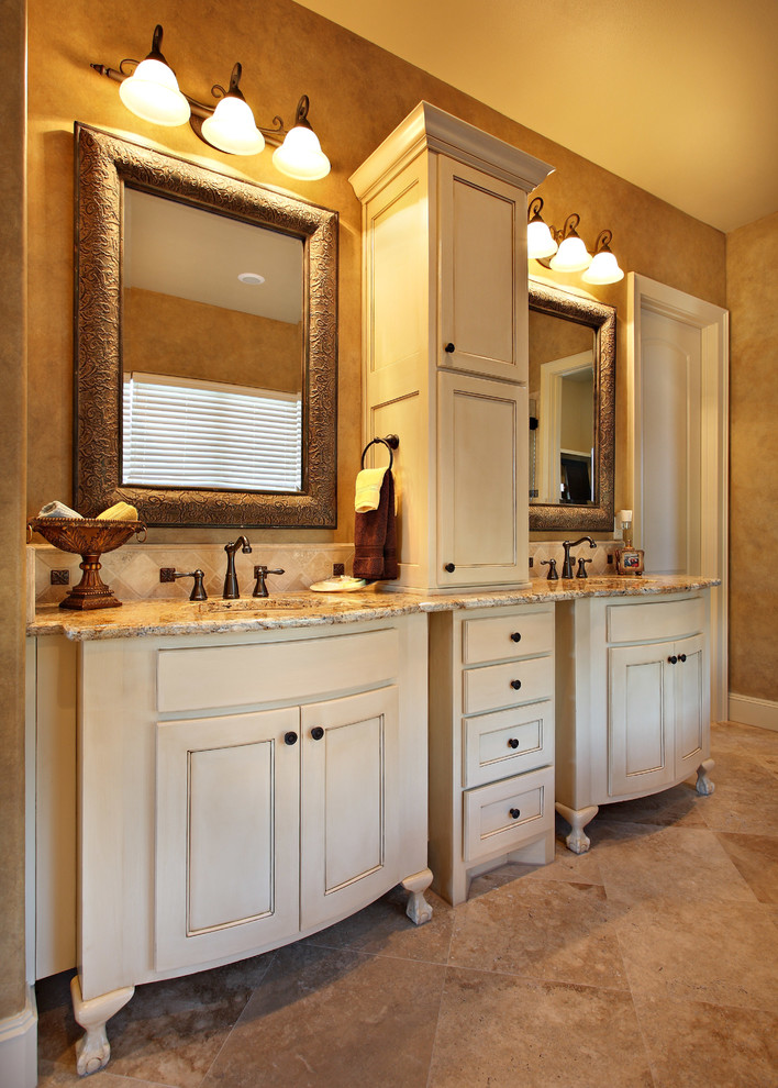 Inspiration for a mid-sized timeless master beige tile and ceramic tile travertine floor bathroom remodel in Austin with beaded inset cabinets, beige cabinets, brown walls, an undermount sink and granite countertops
