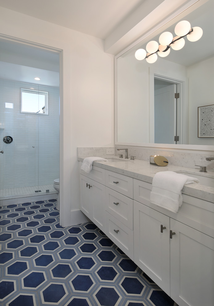 Large beach style 3/4 white tile and subway tile vinyl floor and multicolored floor alcove shower photo in Orange County with shaker cabinets, white cabinets, white walls, an undermount sink, granite countertops, a hinged shower door and white countertops