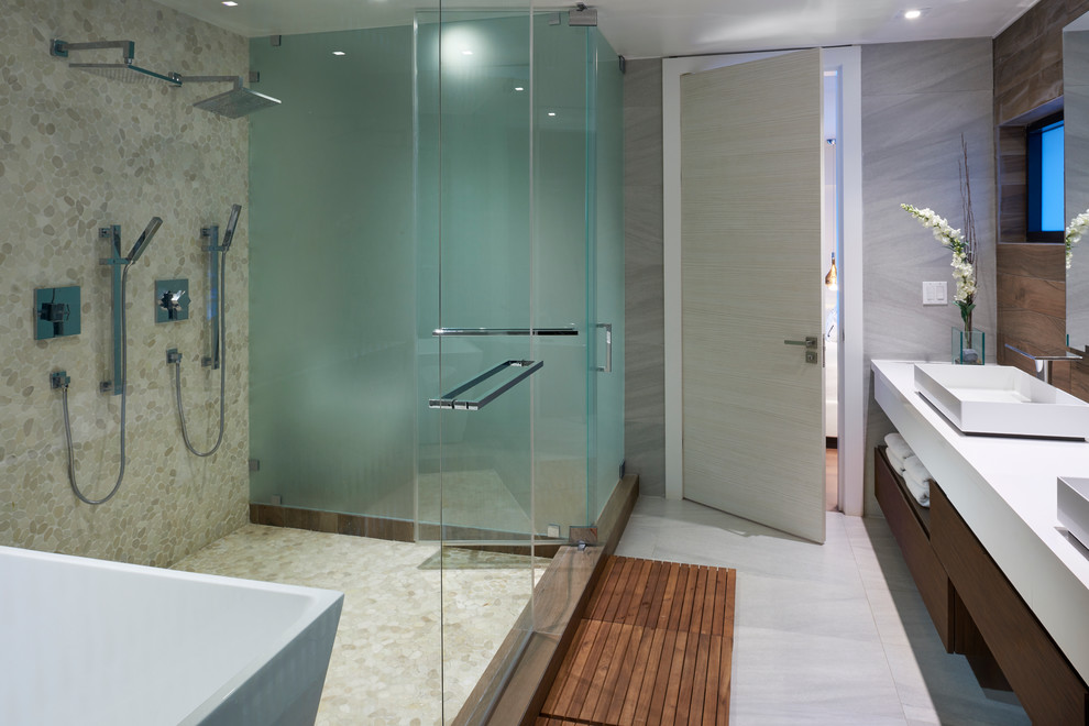 Ispirazione per una stanza da bagno padronale minimal di medie dimensioni con ante lisce, ante in legno scuro, vasca freestanding, doccia doppia, WC monopezzo, piastrelle grigie, piastrelle in ceramica, pareti grigie, pavimento in cementine, lavabo a bacinella e top in quarzo composito