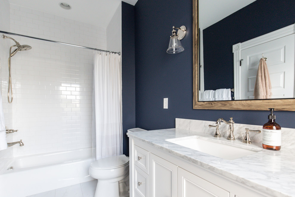 Traditional family bathroom in Richmond with shaker cabinets, white cabinets, a built-in bath, a two-piece toilet, white tiles, metro tiles, blue walls, ceramic flooring, a submerged sink, marble worktops and white floors.