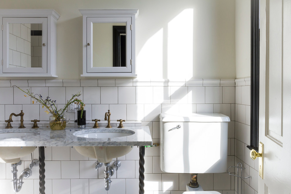 Example of a mid-sized classic master white tile and ceramic tile ceramic tile doorless shower design in Other with open cabinets, marble countertops, a wall-mount toilet, white walls and a console sink