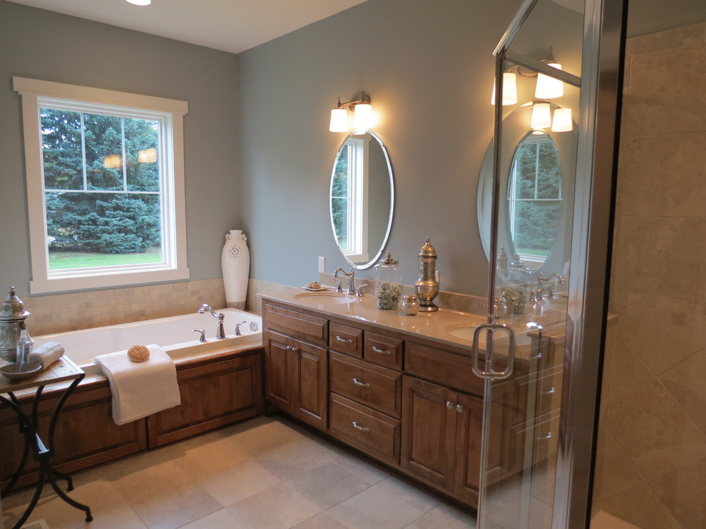 Bathroom - french country master gray floor and double-sink bathroom idea with raised-panel cabinets, light wood cabinets, gray walls, an undermount sink, a hinged shower door, beige countertops and a built-in vanity