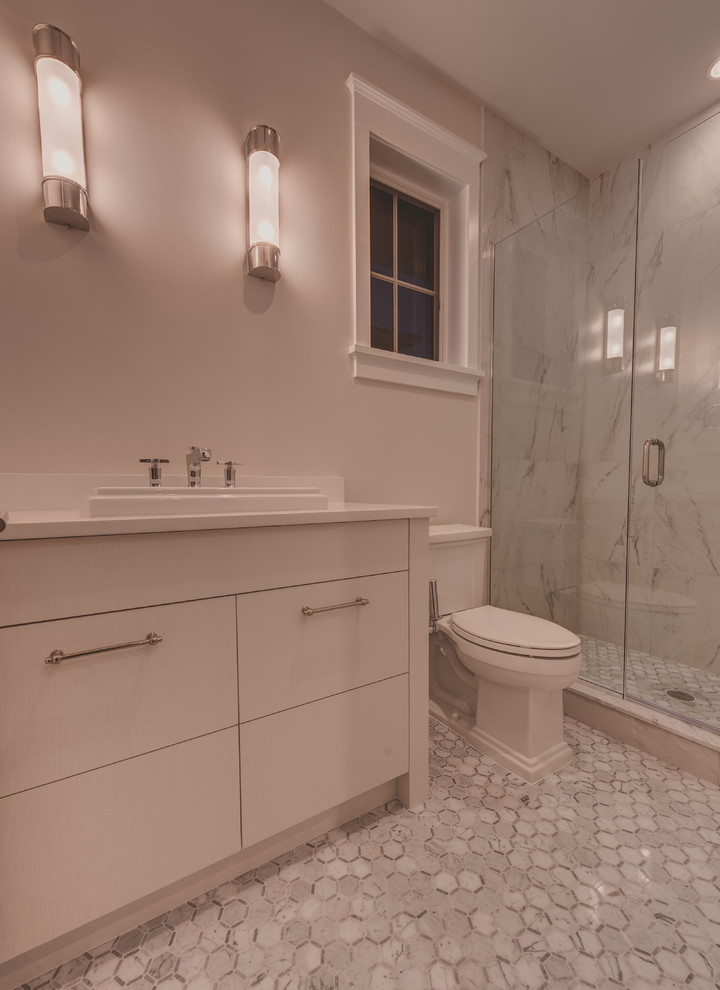 Example of a mid-sized transitional 3/4 gray tile corner shower design in Miami with a drop-in sink, flat-panel cabinets, white cabinets, marble countertops, a one-piece toilet and gray walls
