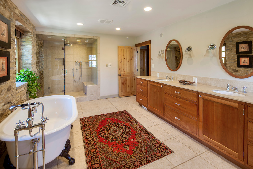Mountain style master light wood floor claw-foot bathtub photo in Philadelphia with light wood cabinets