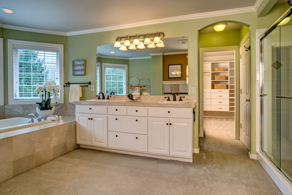 This is an example of a medium sized classic ensuite bathroom in Seattle with a built-in sink, raised-panel cabinets, white cabinets, tiled worktops, a built-in bath, an alcove shower, beige tiles, ceramic tiles and green walls.