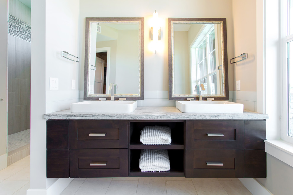 Inspiration for a large transitional master gray tile marble floor bathroom remodel in Phoenix with a vessel sink, shaker cabinets, dark wood cabinets, granite countertops, a two-piece toilet and gray walls