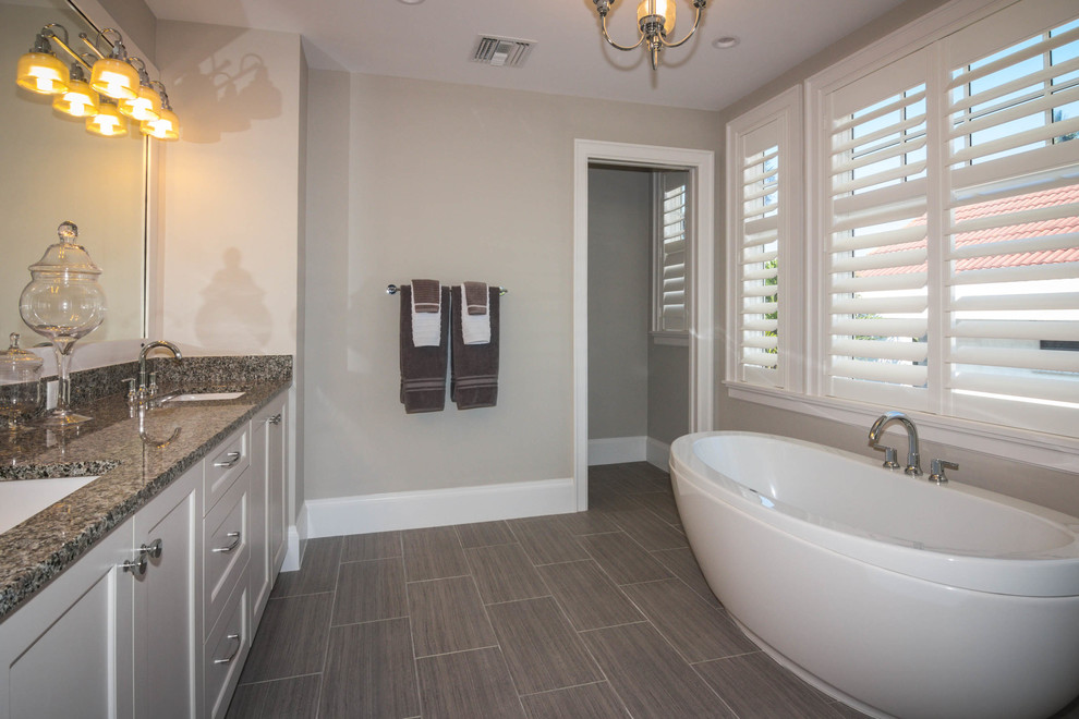 Inspiration for a mid-sized timeless 3/4 multicolored tile and mosaic tile porcelain tile alcove shower remodel in Phoenix with shaker cabinets, white cabinets, a two-piece toilet, gray walls, an undermount sink and granite countertops