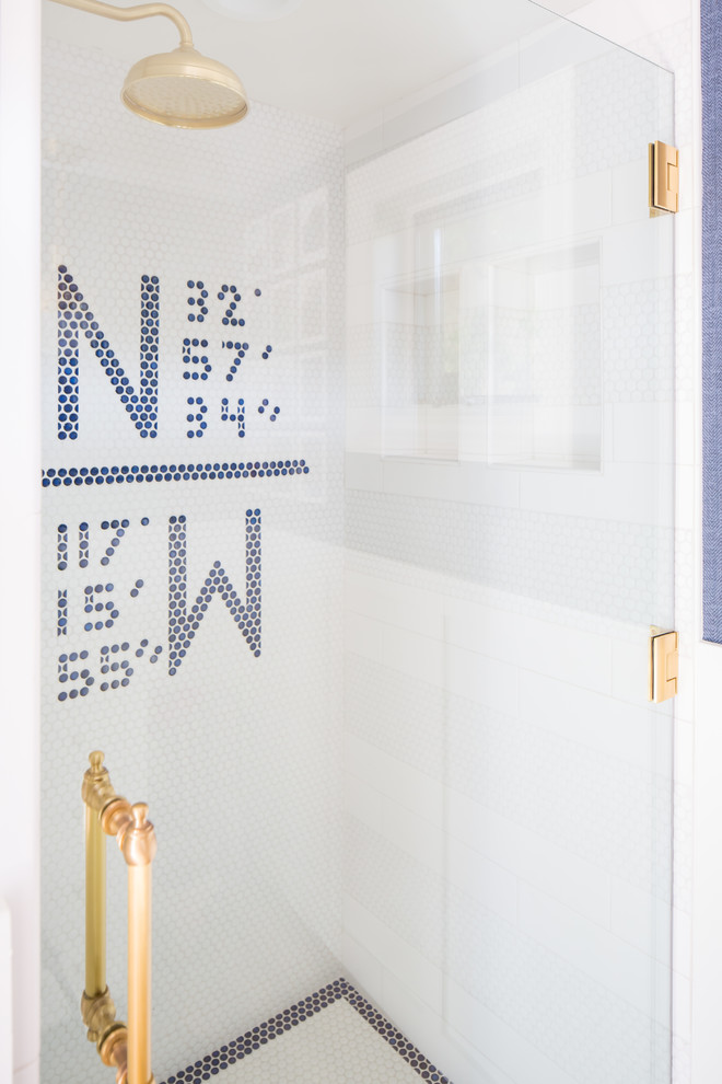 This is an example of a traditional bathroom in San Diego with louvered cabinets, white cabinets, an alcove shower, pebble tiles, blue walls, marble worktops and a hinged door.