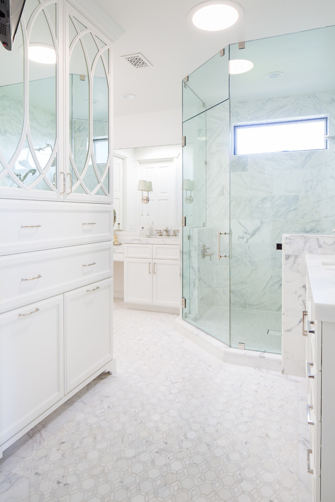 Inspiration for a transitional master marble tile marble floor corner shower remodel in San Diego with shaker cabinets, white cabinets, white walls, marble countertops and a hinged shower door
