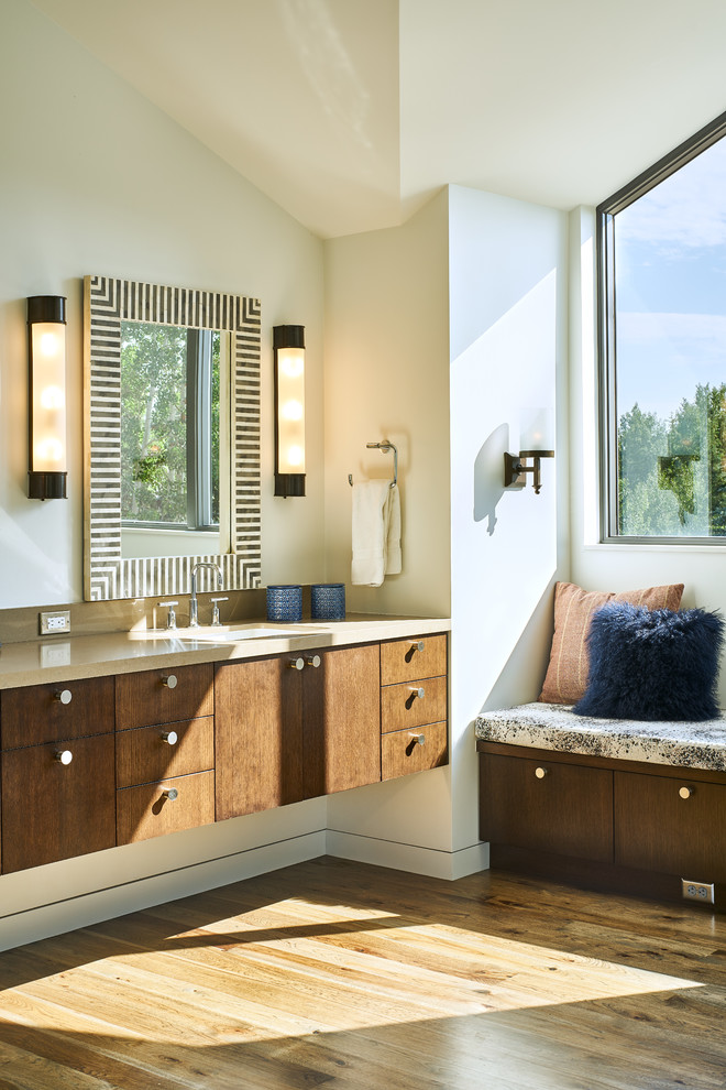 Bathroom - large contemporary master brown tile and porcelain tile dark wood floor and brown floor bathroom idea in Salt Lake City with flat-panel cabinets, dark wood cabinets, a one-piece toilet, white walls, a wall-mount sink, solid surface countertops and a hinged shower door