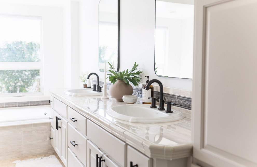 Inspiration for a mid-sized eclectic master beige tile and ceramic tile ceramic tile, beige floor and double-sink bathroom remodel in Phoenix with shaker cabinets, beige cabinets, a one-piece toilet, white walls, tile countertops, beige countertops and a built-in vanity