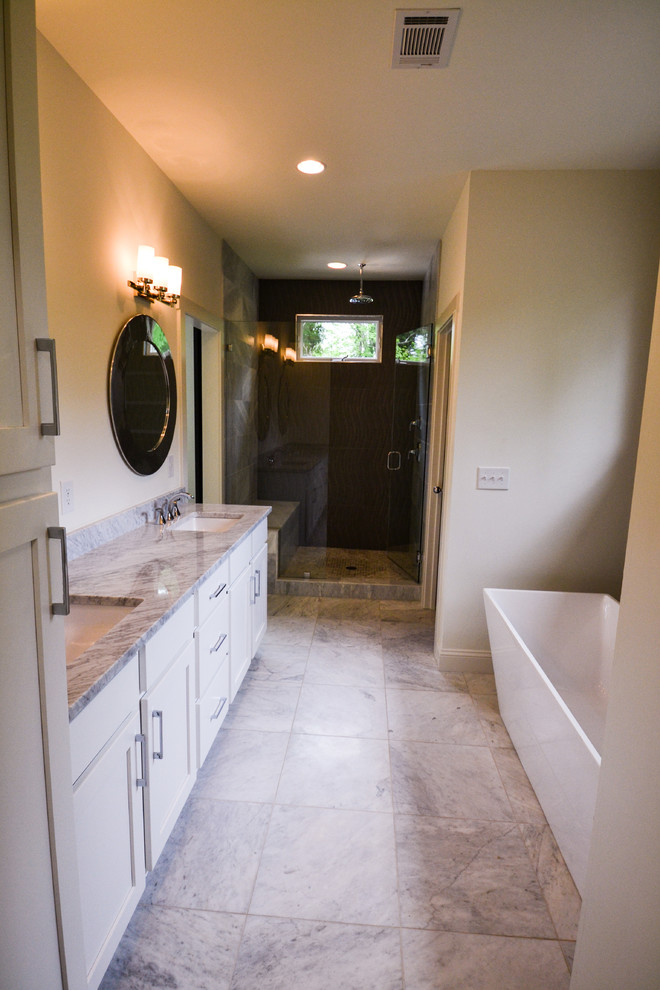 Example of a mid-sized transitional master gray tile and porcelain tile marble floor and gray floor bathroom design in Atlanta with shaker cabinets, white cabinets, white walls, an undermount sink, marble countertops, a hinged shower door and gray countertops