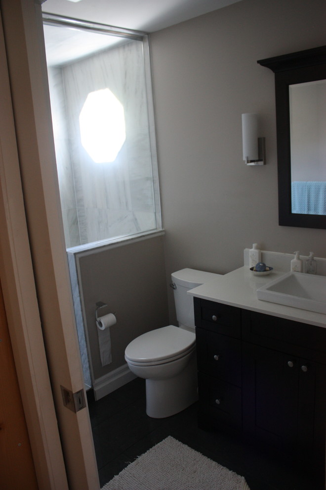 Medium sized contemporary bathroom in Toronto with a built-in sink, freestanding cabinets, dark wood cabinets, quartz worktops, a double shower, a two-piece toilet, white tiles, stone tiles, beige walls and ceramic flooring.