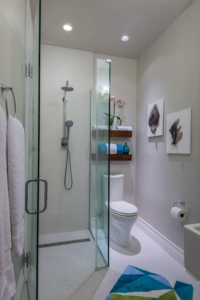 Inspiration for a small coastal shower room bathroom in New York with a wall-mounted sink, a built-in shower, a two-piece toilet, white tiles, porcelain tiles, grey walls and ceramic flooring.