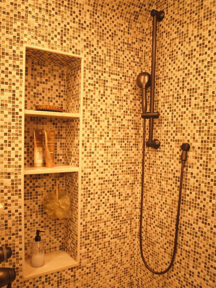 Inspiration for a mid-sized mediterranean master multicolored tile and mosaic tile ceramic tile and beige floor corner shower remodel in Newark with flat-panel cabinets, medium tone wood cabinets, a two-piece toilet, beige walls, an undermount sink, quartz countertops and a hinged shower door