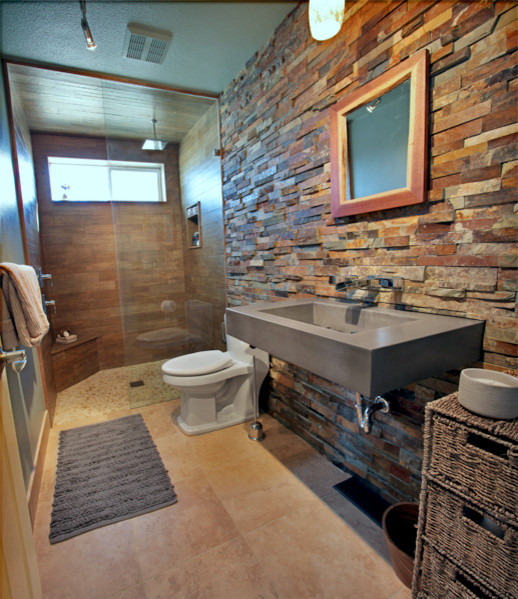 Idée de décoration pour une salle de bain design avec un lavabo suspendu et un plan de toilette en béton.
