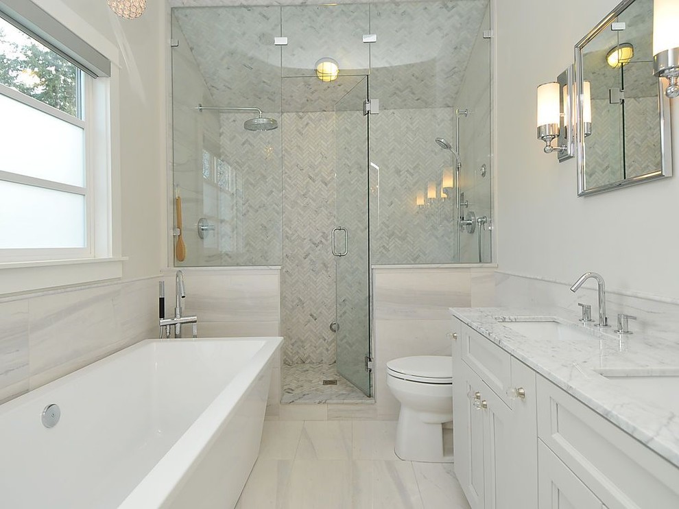 Contemporary half tiled bathroom in Vancouver with a freestanding bath.