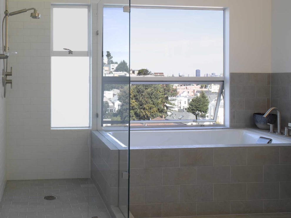 Bathroom - modern subway tile bathroom idea in San Francisco with white walls and a hinged shower door