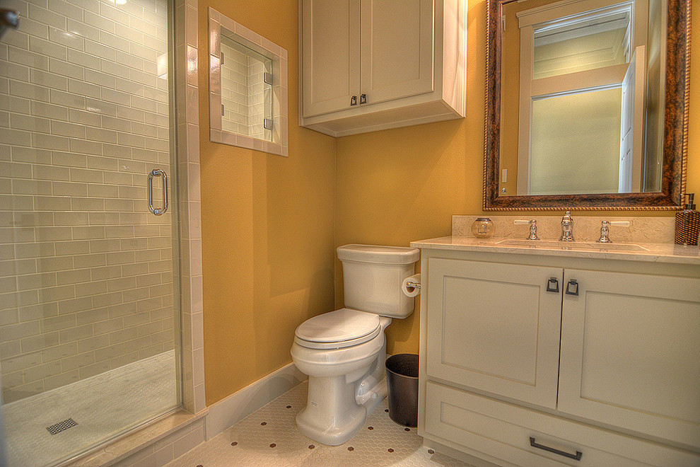 Example of a large classic kids' beige tile and ceramic tile ceramic tile doorless shower design in Dallas with shaker cabinets, white cabinets, a two-piece toilet, yellow walls, an undermount sink and marble countertops