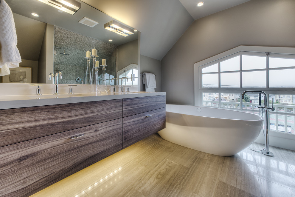 Example of a minimalist bathroom design in San Francisco with an undermount sink, flat-panel cabinets, medium tone wood cabinets and solid surface countertops