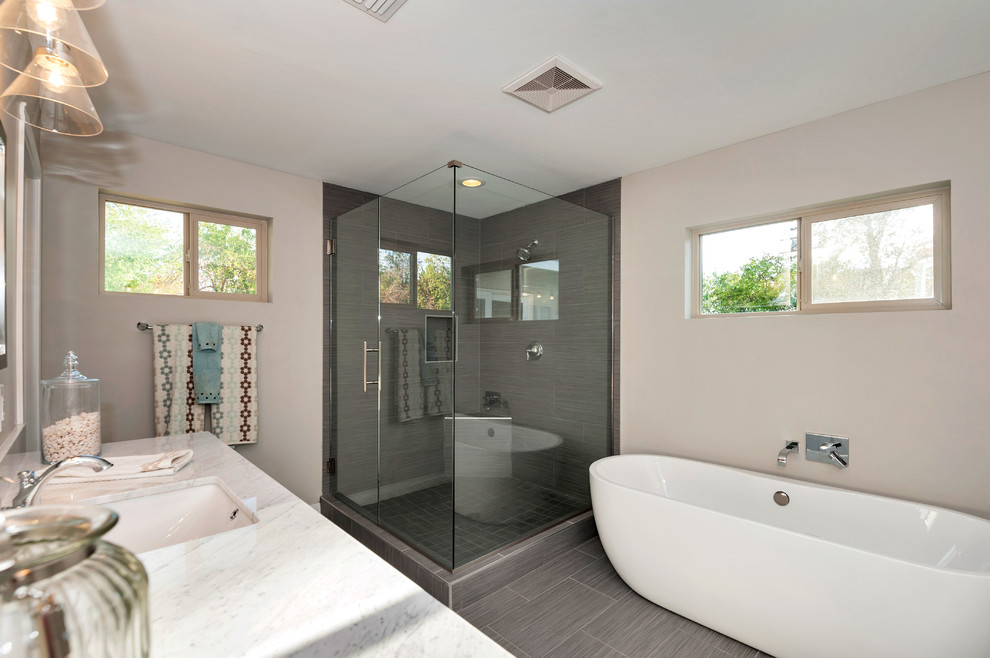 Design ideas for a large traditional ensuite bathroom in Phoenix with a freestanding bath, a corner shower, grey tiles, porcelain tiles, grey walls, porcelain flooring, a submerged sink and marble worktops.