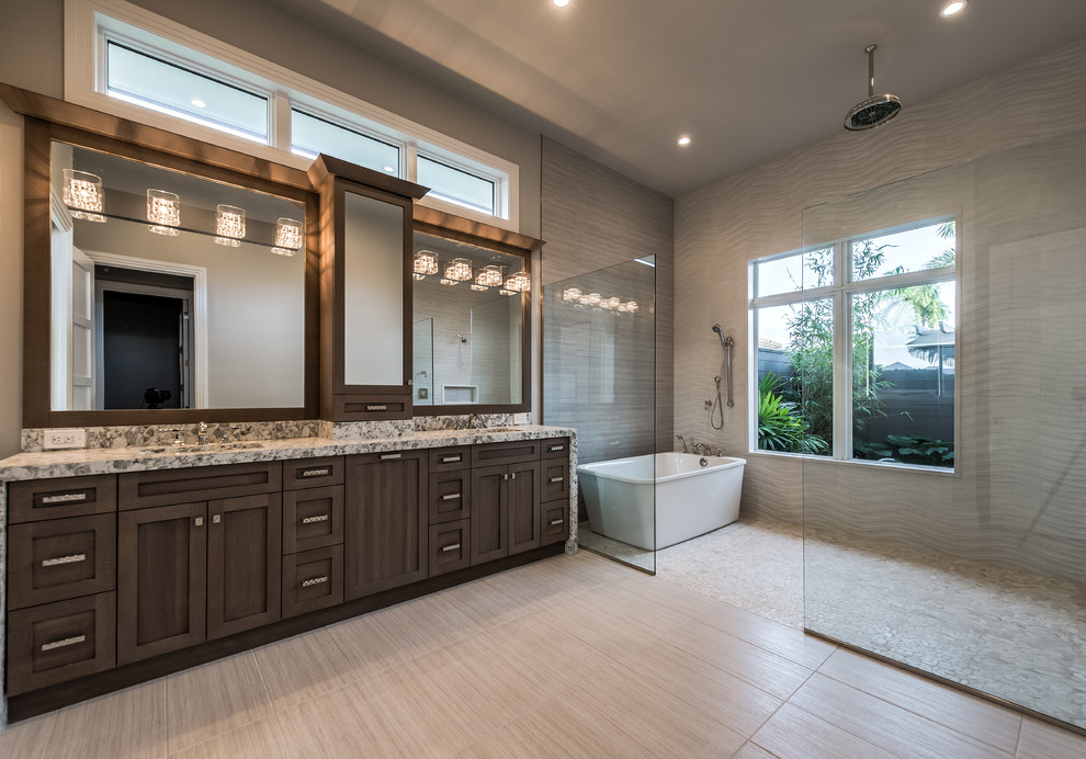 Large ensuite bathroom in Miami with dark wood cabinets, a freestanding bath, a double shower, grey tiles, ceramic tiles, grey walls, ceramic flooring, a built-in sink and granite worktops.