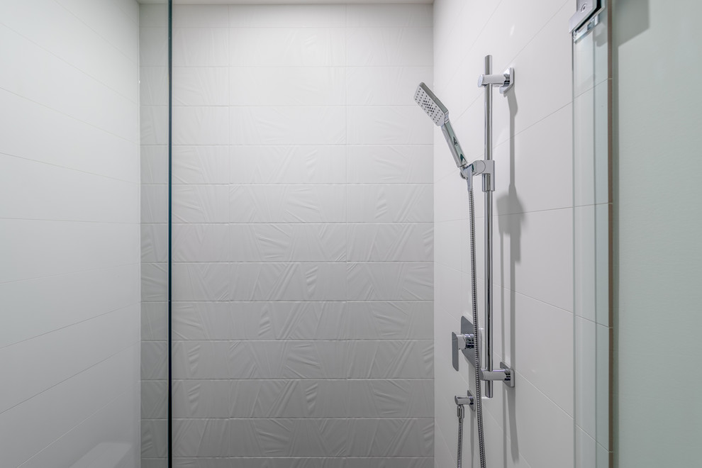 Modern inredning av ett mellanstort badrum med dusch, med luckor med upphöjd panel, ett fristående badkar, en hörndusch, en toalettstol med hel cisternkåpa, vita väggar, ett undermonterad handfat och dusch med gångjärnsdörr
